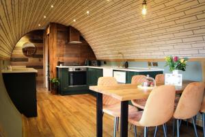 a kitchen with a table and chairs in a room at Hedgehogs View in Rhayader