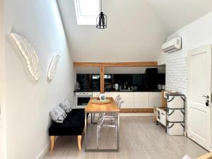 a kitchen with a wooden table and a dining room at Apartamenty Rajcza in Rajcza