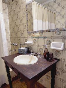 a bathroom with a sink and a mirror at Posada Don Salvador in San Antonio de Areco