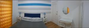 a bedroom with a bed and two night stands at B&B Rivalta - Posillipo in Naples