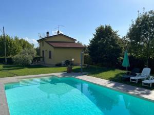 una piscina in un cortile con una casa di Papà Giuseppe La Terrazza a Cortona