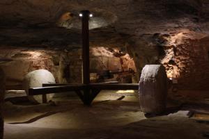 a room with a table in a cave at Masseria Valente in Ostuni