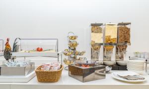 a buffet with dishes and other items on a table at Hotel Isabella Sorrento in Sorrento