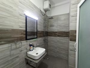a bathroom with a white sink and a shower at 3 bedroom fully furnished apartment - Vel residencies in Colombo