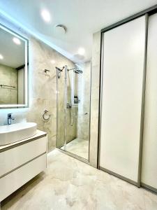 a bathroom with a shower and a sink at Luxury Central Apartment in Putvinskio street in Kaunas