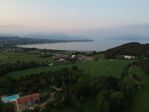 an aerial view of a town and a body of water at Agriturismo B&B Cascina Reciago in Desenzano del Garda