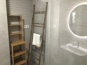 a bathroom with a sink and a ladder next to a mirror at Castillo del Mar in Almuñécar +68 photos