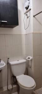 a bathroom with a white toilet and a sink at 2 BR staycation beside Enchanted Kingdom in Santa Rosa