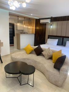 a living room with a couch and a bed at YP George in Lekki
