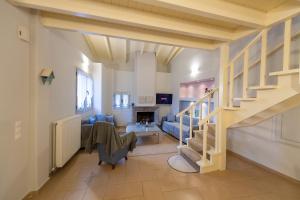 a living room with a staircase and a couch at Summit Guest House in Kalavrita