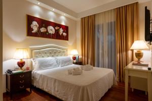 a bedroom with a bed with two towels on it at M House Art Hotel in Milano Marittima