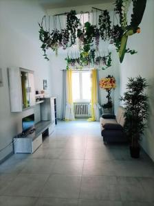 a living room with a couch and a window at Appartamento in centro Cuneo. in Cuneo