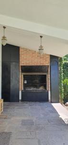 a brick wall with a fireplace in a house at Casa Grande Salta pleno centro de la ciudad in Salta