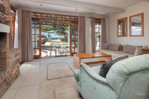 a living room with a couch and a fireplace at Harbour House Hotel - Manor House in Hermanus