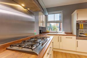 a kitchen with a stove top oven next to a window at City Centre 3 Bed - Perfect for Contractors and Families in Doncaster