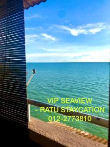 a view of the ocean from a window with a sign at PD VIP SEAVIEW w Wifi n Smart TV in Port Dickson