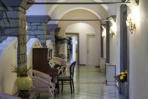a hallway of a house with a table and chairs at Hotel Nettuno in Ischia