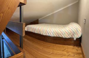 a bed sitting on a wooden floor in a room at OpenSpace Vista Panoramica in Abetone +23 photos