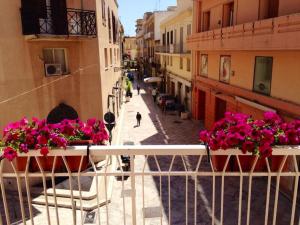 a view of a street with flowers on a balcony at Casa Kina Marsala in Marsala