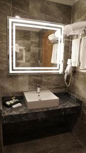 a bathroom with a sink and a mirror at Green Prusa Hotel in Bursa