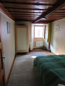 a bedroom with a bed and a window in it at Casetta AnnyCa in Bourg-Saint-Pierre