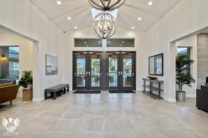 a lobby with a large door and a chandelier at Zion Village Elements Fire in Hurricane +56 photos