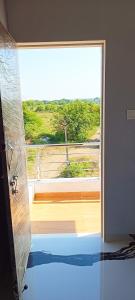 a room with a large glass door leading to a balcony at Matoshree Guesthouse in Akalkot