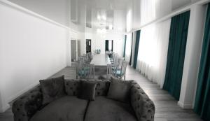 a living room with a couch and a table with chairs at Pensiunea Lor in Sighetu Marmaţiei