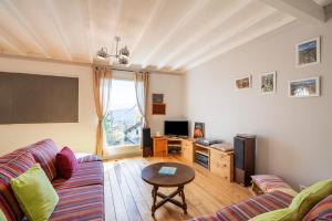 a living room with a couch and a table at Chalet des Eglantines in Les Angles