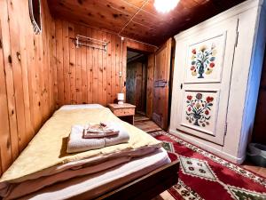 a bedroom with a bed in a wooden room at Albergo Ristorante Selva in Poschiavo