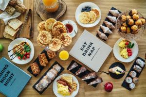 a table full of different types of food on plates at M House Art Hotel in Milano Marittima