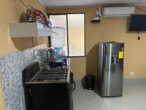 a kitchen with a stove and a refrigerator at Havana in Rivas