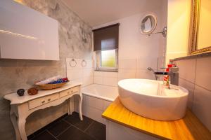a bathroom with a large white sink and a tub at Modern Luxury Villa Antonia in Mössingen +36 photos