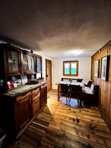 a kitchen with a table and a dining room at Albergo Ristorante Selva in Poschiavo