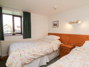 a bedroom with two beds and a window at Gateside in Pickering