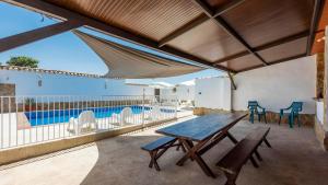 a patio with a table and chairs and a swimming pool at Cortijo El Llano Priego de Córdoba by Ruralidays in Priego de Córdoba