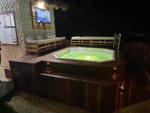 a jacuzzi tub in a room with a tv at Casa Mangue in Macapá +64 photos