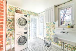 a bathroom with a washing machine and a sink at Walkable Dennis Cottage The Blue Scallop in Dennis