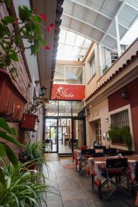 an empty patio with tables and chairs in a building at Hotel Italia in Villa Carlos Paz
