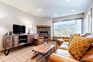 a living room with a couch and a tv at Steamboat Resort Villas 608 in Steamboat Springs