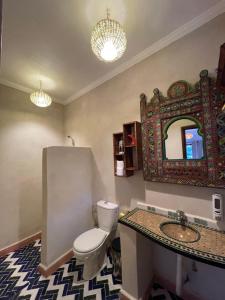 a bathroom with a toilet and a sink and a mirror at Riad Atlas 4 seasons in Imlil