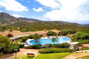 a beach with a pool and trees at Colonna Hotel Country & Sporting in Porto Cervo