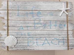 a sign that reads life is at sea at the beach at Gemütliche Ferienwohnung - Araliya 1 in Ahlbeck