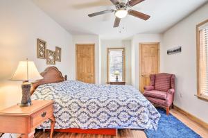a bedroom with a bed and a chair and a ceiling fan at Chestertown Hideaway with Lake and Beach Access! in Chestertown