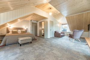 a bedroom with a bed and a chair in a room at Želvė Village & SPA 