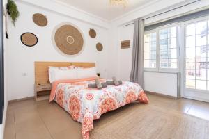 a bedroom with a bed and a large window at Big Room Happy Alicante in Alicante