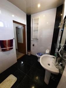 a bathroom with a sink and a toilet at Garni Guesthouse in Garni