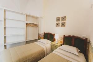 A bed or beds in a room at Masseria La Scalella - Fortificato