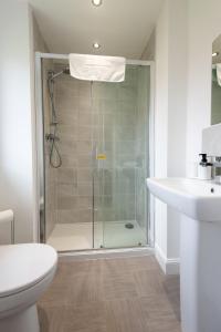 a bathroom with a shower and a toilet and a sink at Bell Road in Durham