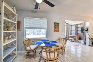 a dining room with a blue table and chairs at Clearwater Retreat Near Beach, Golf, and Boating! in Clearwater
